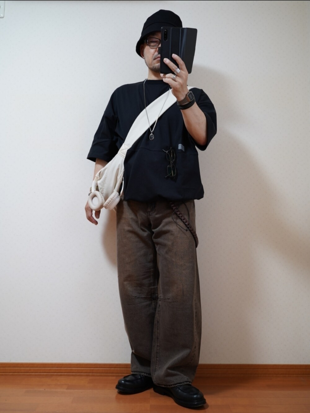 ブラック系のシューズ、ブラウン系のデニムパンツ、ブラック系のTシャツ/カットソーを着用したメンズの夏コーディネートの2枚目の写真