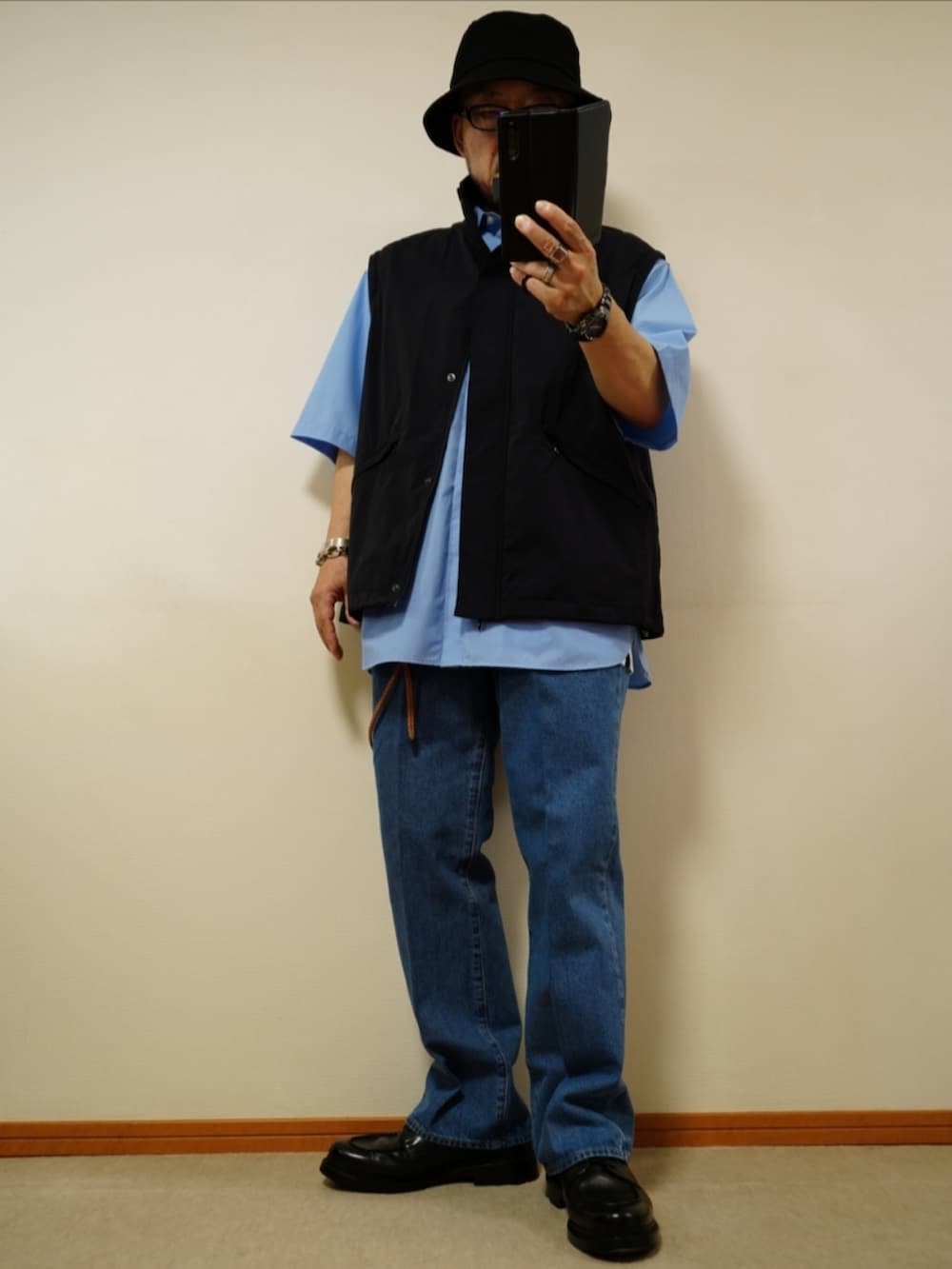 ブラック系のシューズ、ブルー系のデニムパンツ、ホワイト系のタンクトップを着用したメンズの夏コーディネートの2枚目の写真