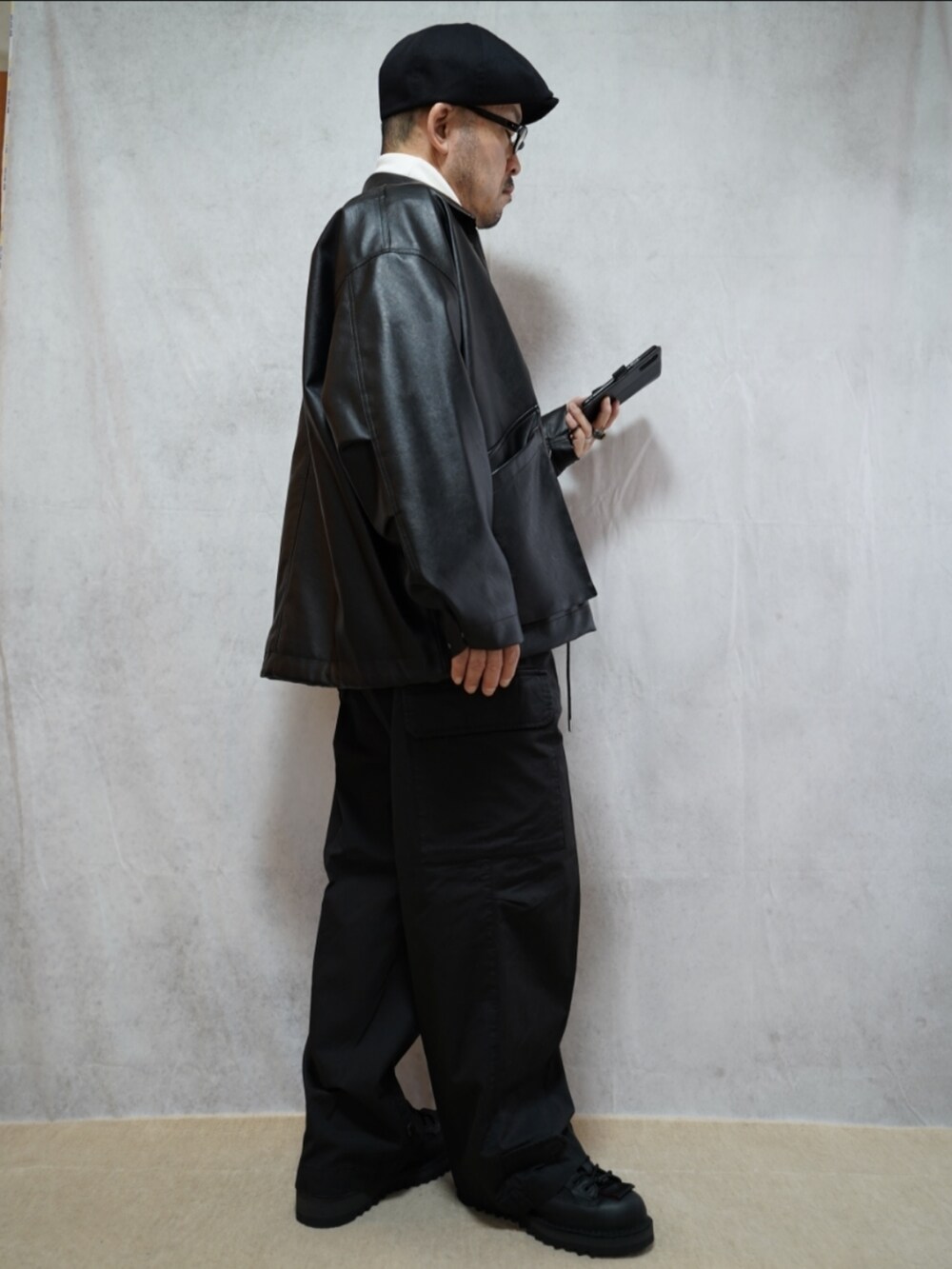 ブラック系のシューズ、グレー系のカーゴパンツ、ホワイト系のTシャツ/カットソーを着用したメンズの冬コーディネートの4枚目の写真
