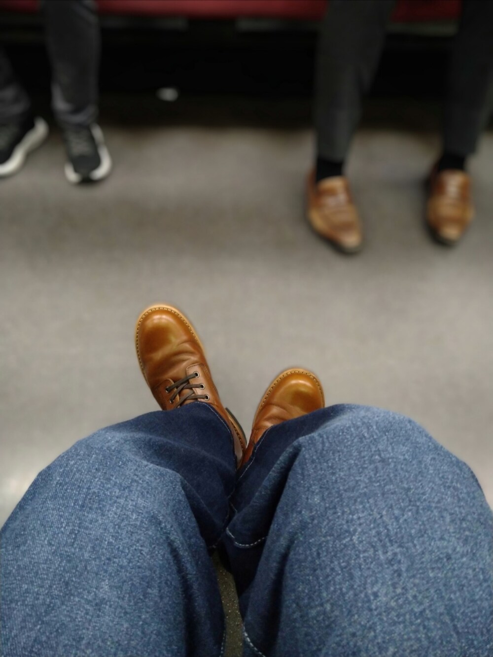 ブラウン系のブーツ、ブルー系のデニムパンツ、ブラック系のブルゾンを着用したメンズの春コーディネートの3枚目の写真