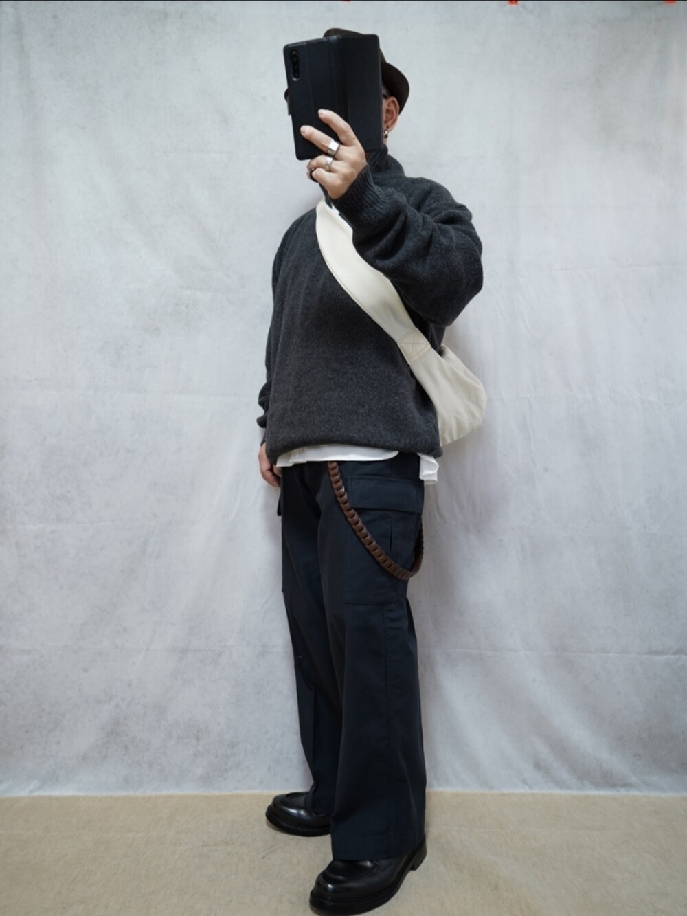 ブラック系のシューズ、グレー系のパンツ、グレー系のニット/セーターを着用したメンズの冬コーディネートの2枚目の写真