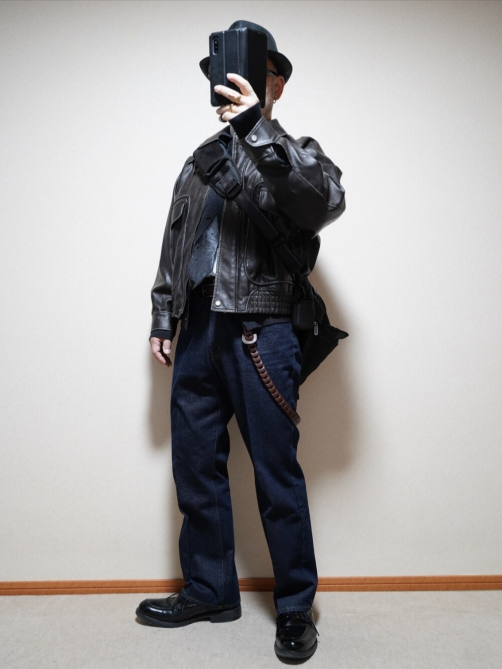 ブラック系のシューズ、ブルー系のデニムパンツ、ブラック系のネクタイを着用したメンズの春コーディネートの2枚目の写真