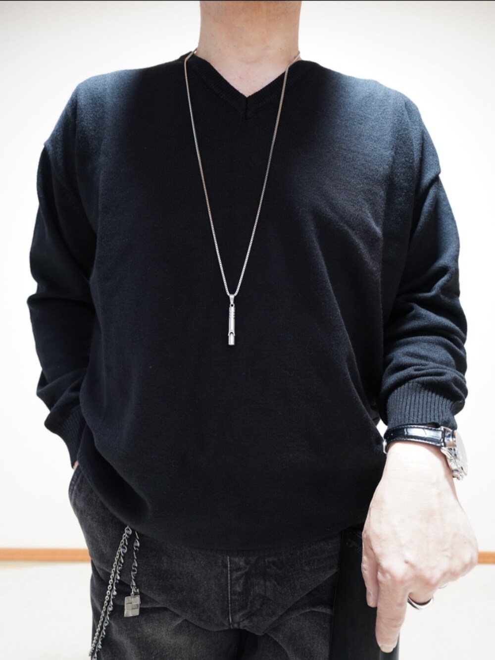 ブラック系のシューズ、ブラック系のデニムパンツ、ブラック系のニット/セーターを着用したメンズの春コーディネートの4枚目の写真