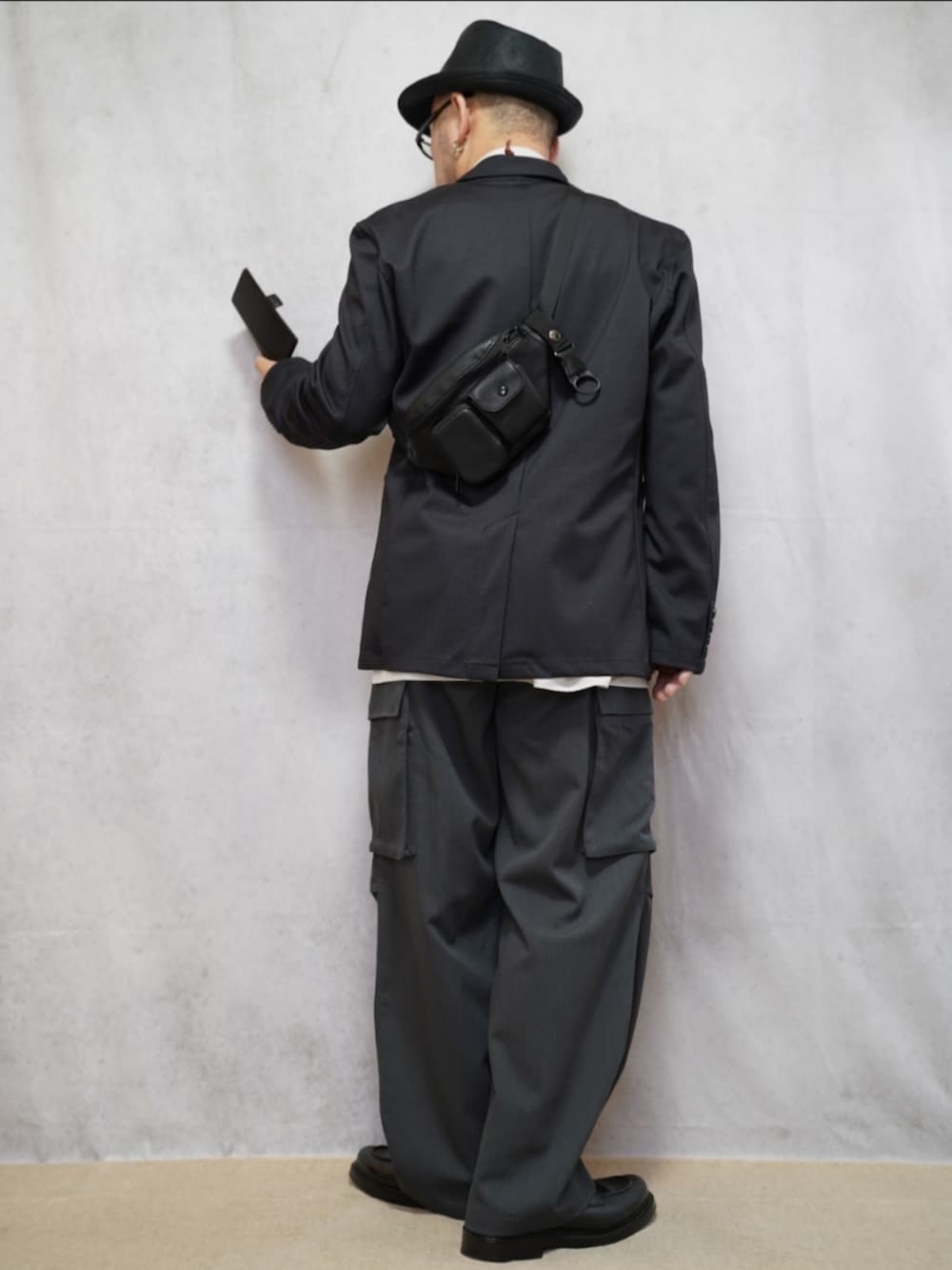 ブラック系のシューズ、グレー系のカーゴパンツ、ホワイト系のシャツ/ブラウスを着用したメンズの春コーディネートの3枚目の写真