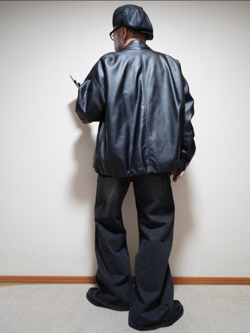 ブラック系のシューズ、ブラック系のデニムパンツ、ブラック系のニット/セーターを着用したメンズの冬コーディネートの3枚目の写真