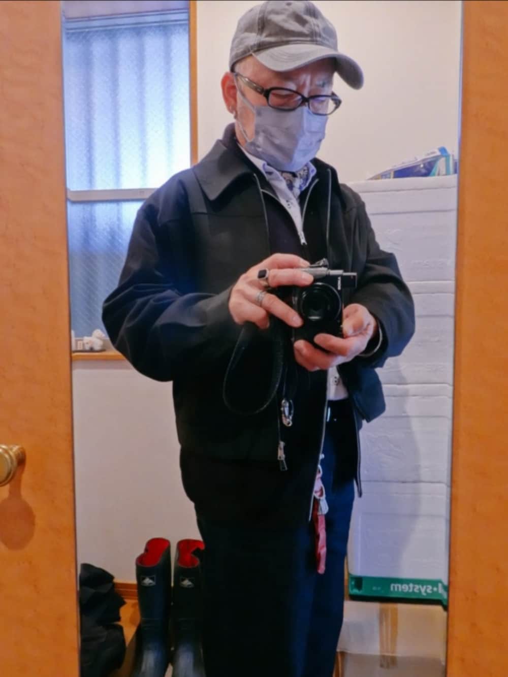 ブラック系のブーツ、ブルー系のデニムパンツ、ブラック系のブルゾンを着用したメンズの春コーディネートの2枚目の写真