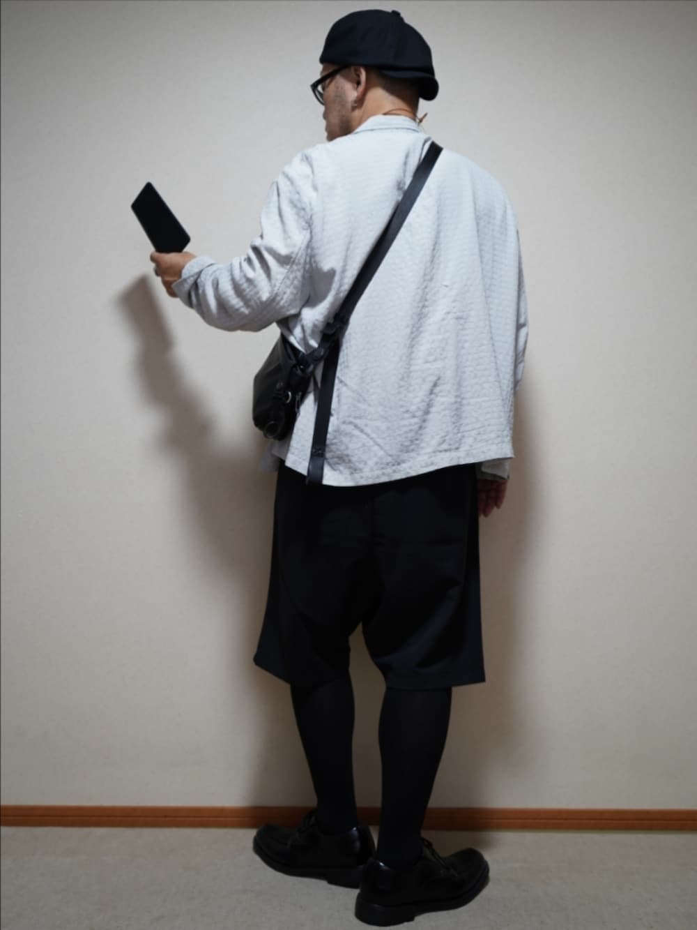 ブラック系のシューズ、ブラック系のその他パンツ、ベージュ系のTシャツ/カットソーを着用したメンズの夏コーディネートの3枚目の写真