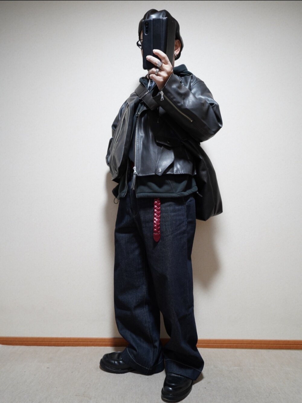 ブラック系のシューズ、ブルー系のデニムパンツ、ブラック系のパーカーを着用したメンズの冬コーディネートの2枚目の写真