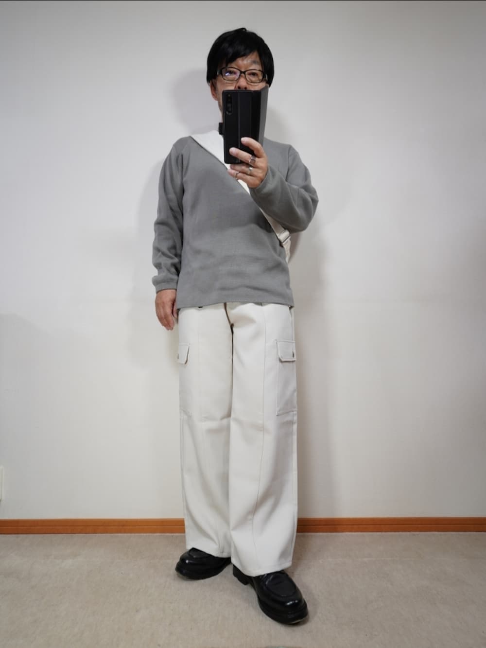 ブラック系のシューズ、ブラウン系のカーゴパンツ、グレー系のニット/セーターを着用したメンズの秋コーディネートの4枚目の写真