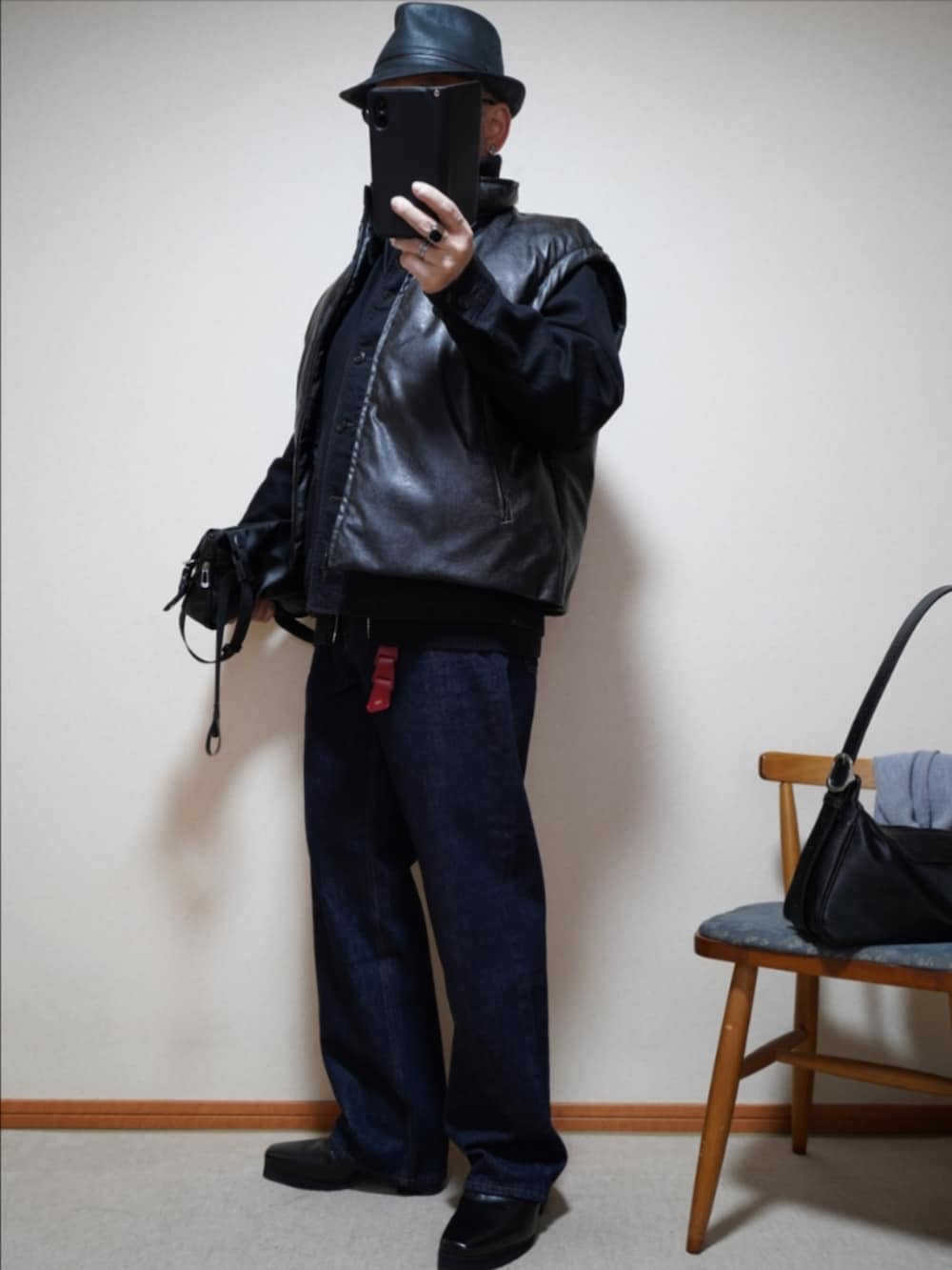 ブラック系のブーツ、ブルー系のデニムパンツ、ブラック系のデニムジャケットを着用したメンズの春コーディネートの2枚目の写真