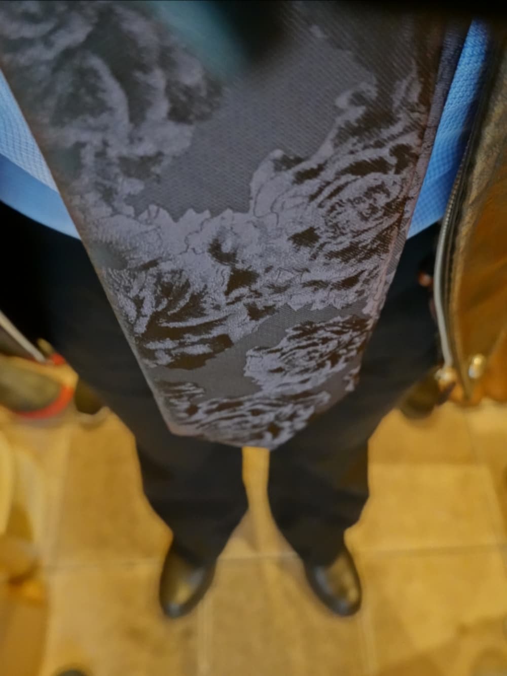 グレー系のデニムパンツ、グレー系のブルゾン、ブルー系のステンカラーコートを着用したメンズの春コーディネートの4枚目の写真