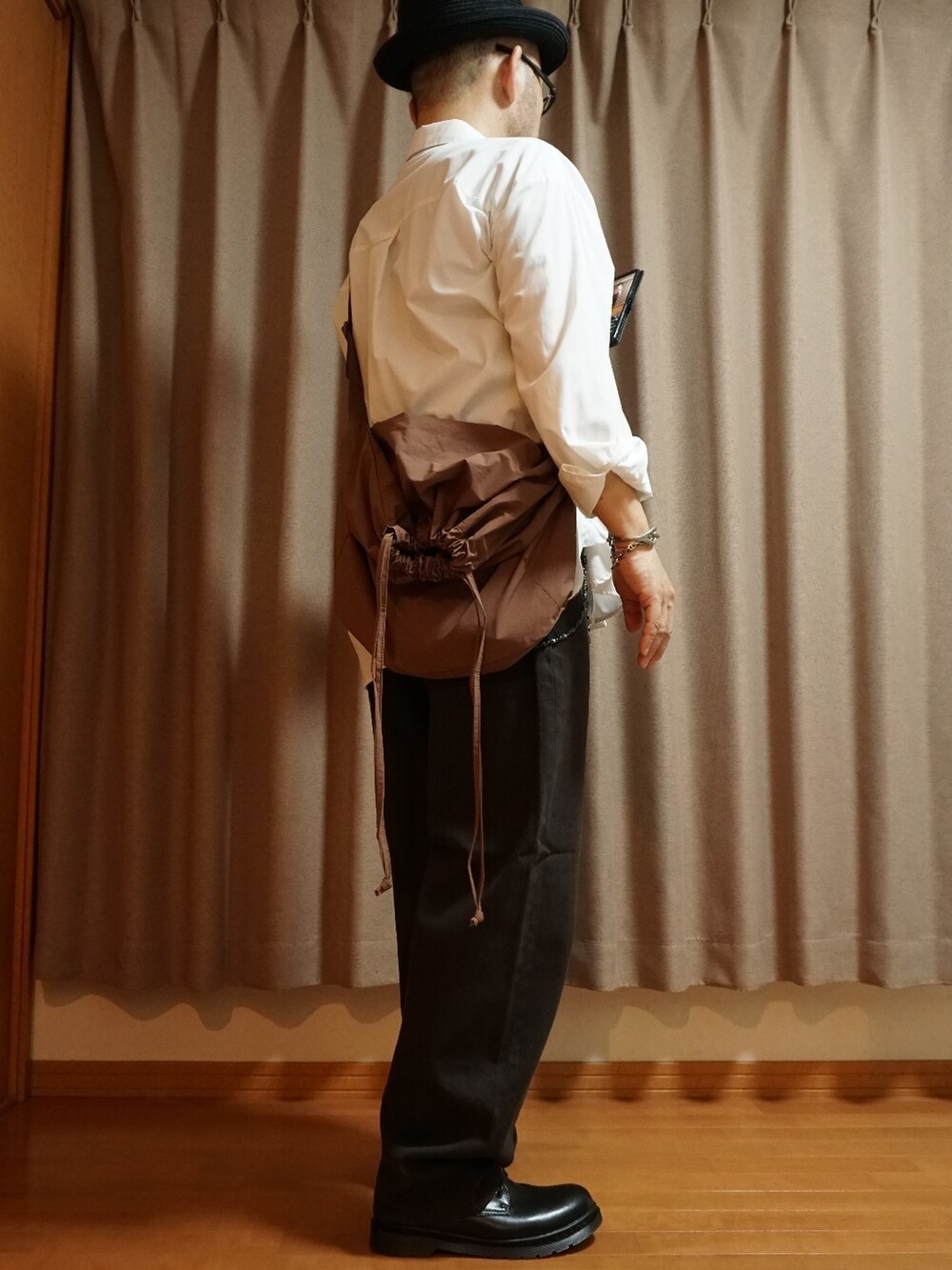 ブラック系のシューズ、ブラウン系のデニムパンツ、ホワイト系のシャツ/ブラウスを着用したメンズの夏コーディネートの2枚目の写真
