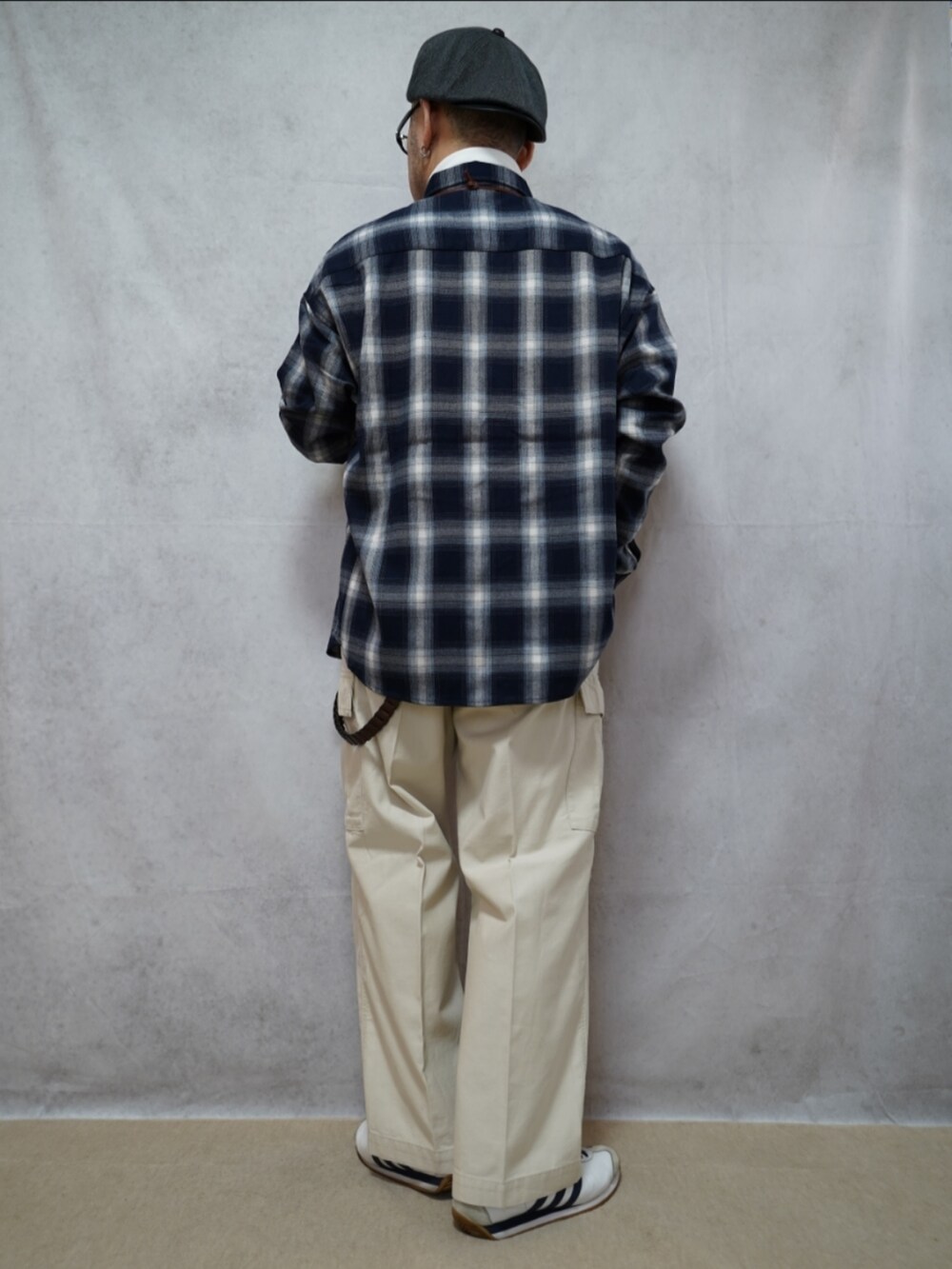 ホワイト系のスニーカー、グレー系のパンツ、ブルー系のシャツ/ブラウスを着用したメンズの春コーディネートの3枚目の写真