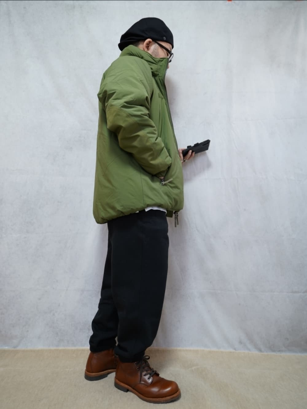 ブラウン系のブーツ、ブラック系のスウェットパンツ、グリーン系のダウンジャケット/コートを着用したメンズの冬コーディネートの4枚目の写真