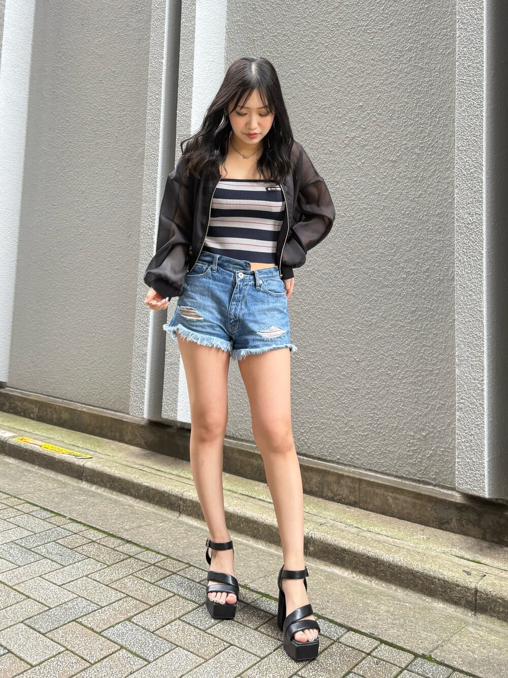 ブラック系のカーディガン/ボレロ、ブルー系のデニムパンツを着用したレディースの夏コーディネートの2枚目の写真