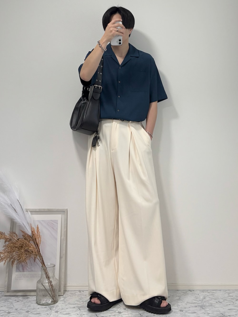 ブルー系のシャツ/ブラウス、ブラック系のハンドバッグ、ホワイト系のスラックスを着用したメンズの夏コーディネートの2枚目の写真