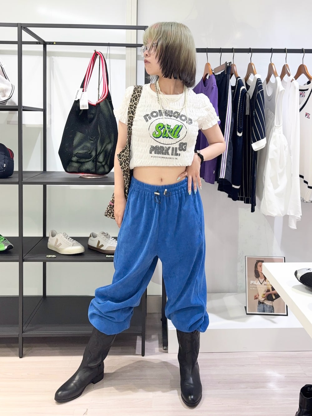 ブラック系のブーツ、ブルー系のその他パンツ、ホワイト系のTシャツ/カットソーを着用したレディースの夏コーディネートの2枚目の写真