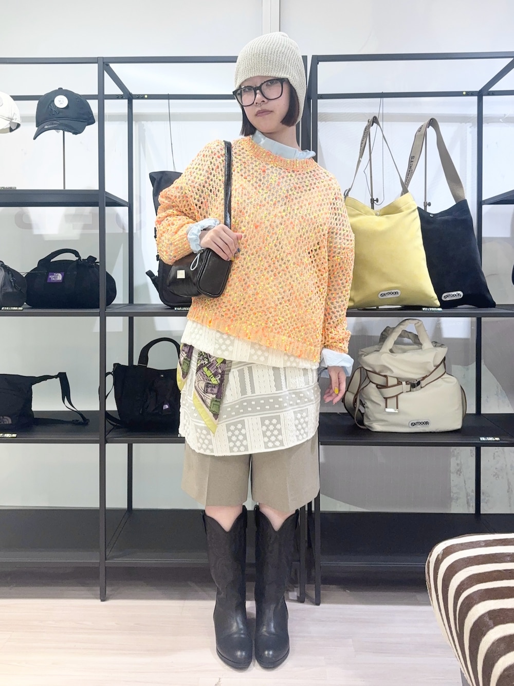 ブルー系のブルゾン、オレンジ系のニット/セーター、ホワイト系のワンピースを着用したレディースの春コーディネートの2枚目の写真