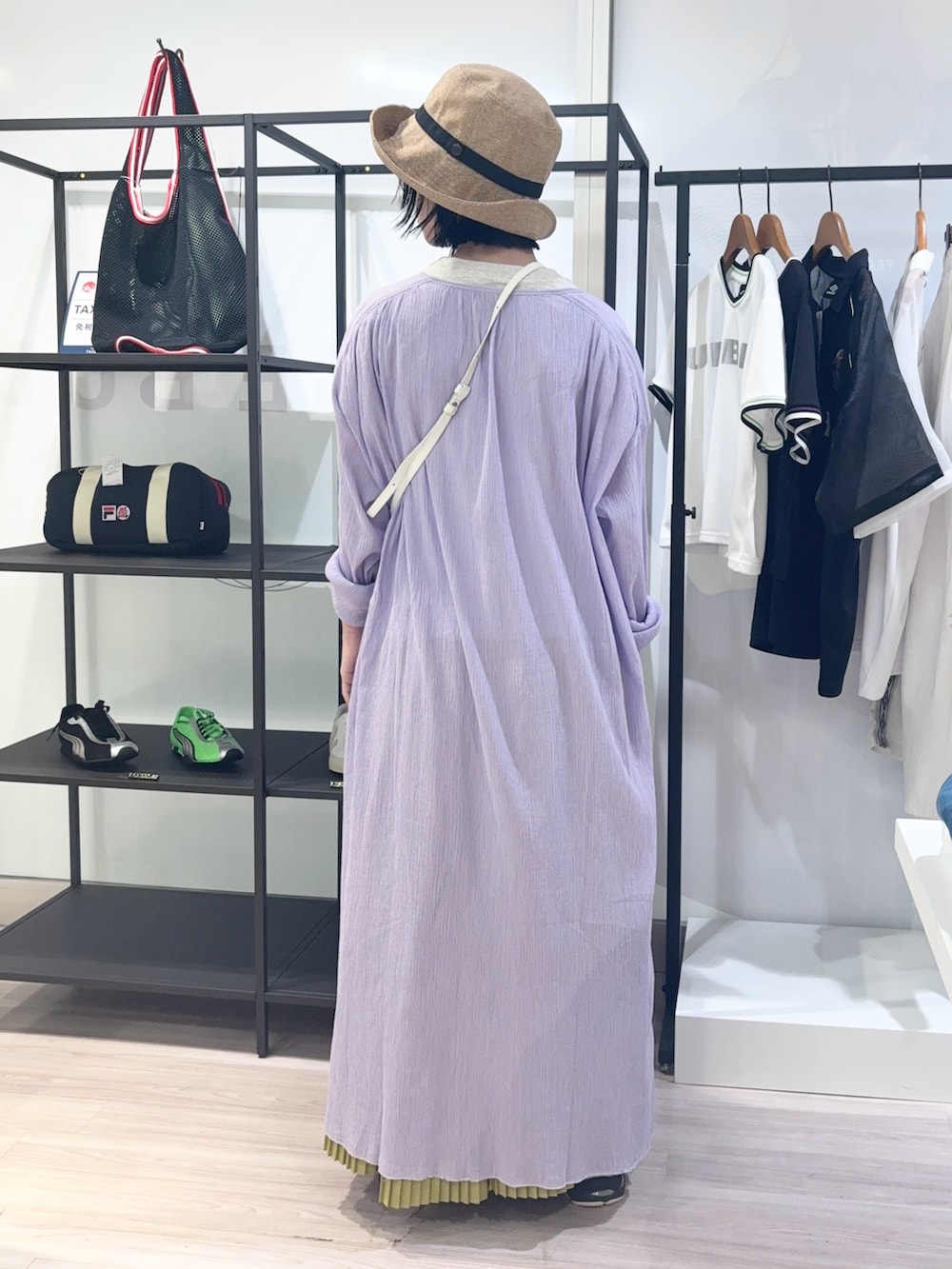 ホワイト系のショルダーバッグ、ベージュ系のTシャツ/カットソー、イエロー系のスカートを着用したレディースの夏コーディネートの4枚目の写真