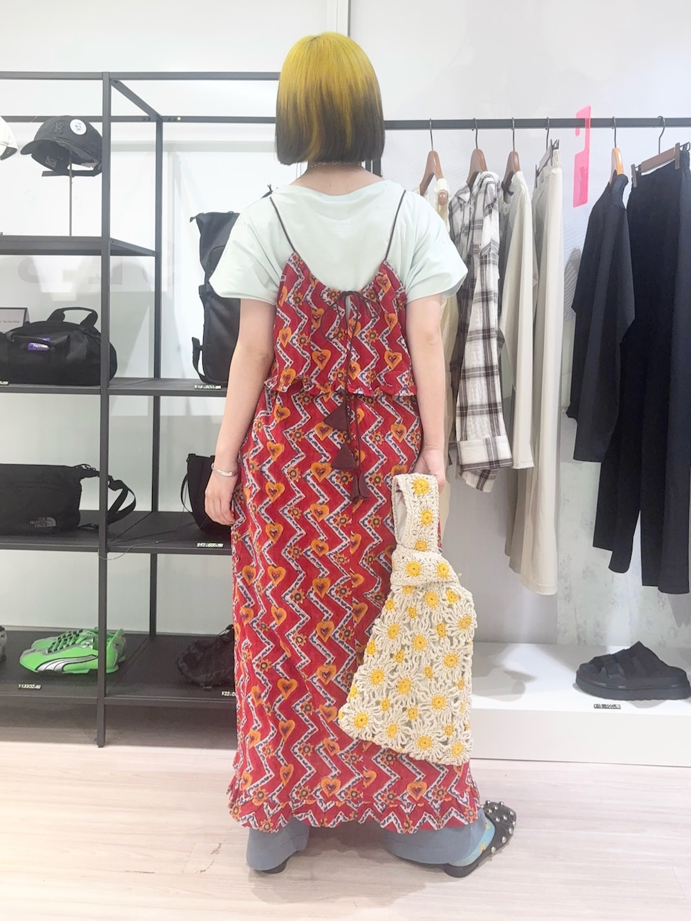 グリーン系のTシャツ/カットソー、イエロー系のショルダーバッグ、レッド系のドレスを着用したレディースの春コーディネートの4枚目の写真