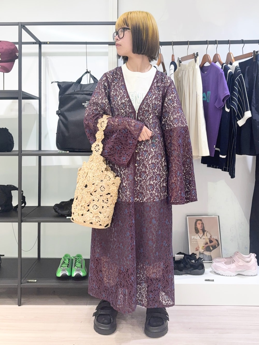 レッド系のワンピース、ホワイト系のTシャツ/カットソー、ベージュ系のショルダーバッグを着用したレディースの春コーディネートの2枚目の写真