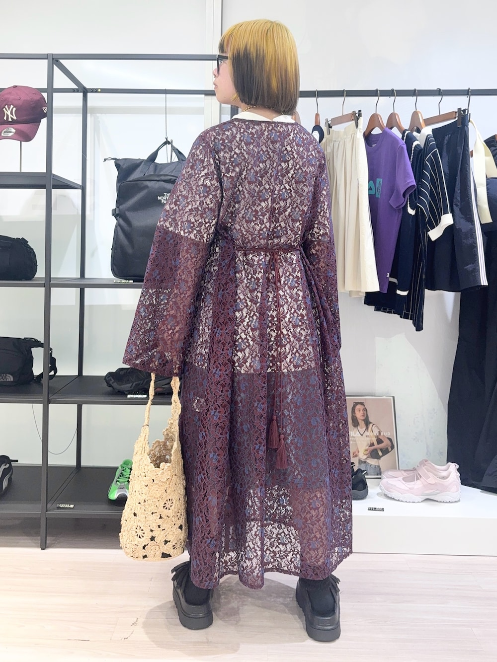 レッド系のワンピース、ホワイト系のTシャツ/カットソー、ベージュ系のショルダーバッグを着用したレディースの春コーディネートの4枚目の写真