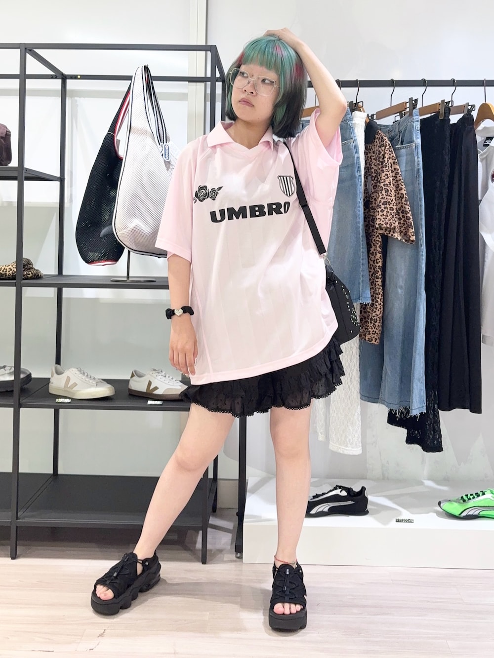 ブラック系のショルダーバッグ、ピンク系のTシャツ/カットソー、ブラック系のサンダルを着用したレディースの夏コーディネートの2枚目の写真