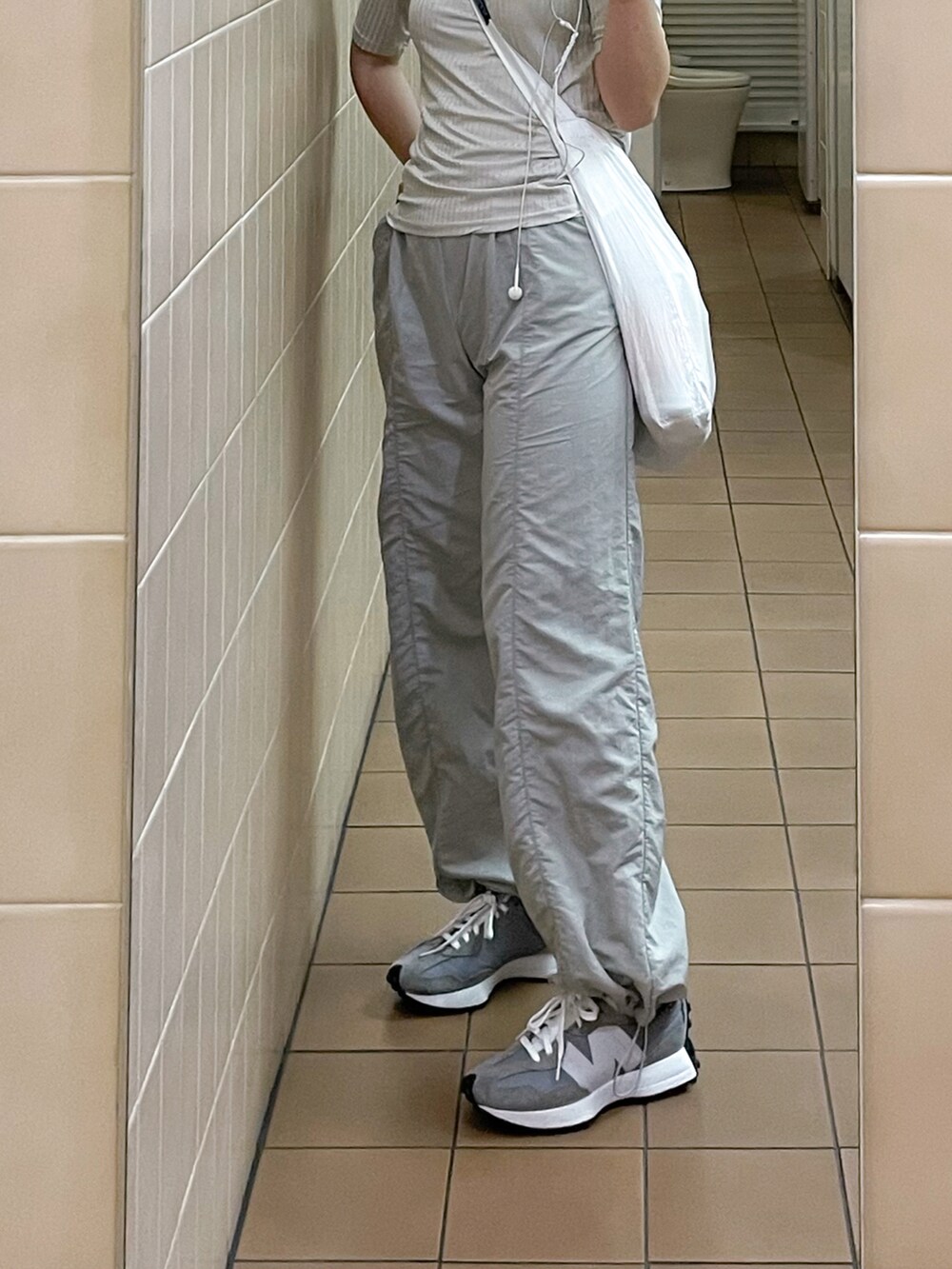 グレー系のスニーカー、シルバー系のパンツ、シルバー系のTシャツ/カットソーを着用したレディースの夏コーディネートの2枚目の写真