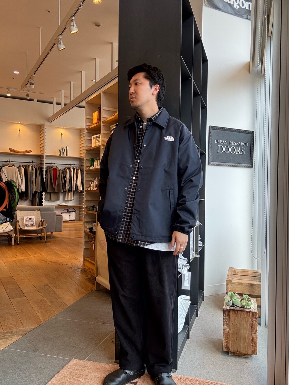 ブルー系のナイロンジャケット、ブラック系のシャツ/ブラウスを着用したメンズの秋コーディネートの2枚目の写真