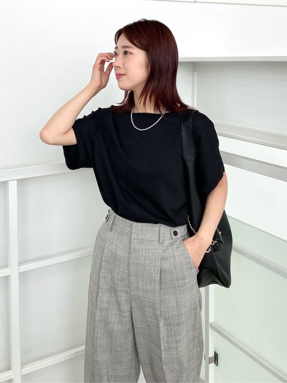 ブラック系のニット/セーター、グレー系のその他パンツ、ブラック系のトートバッグを着用したレディースの春コーディネートの5枚目の写真