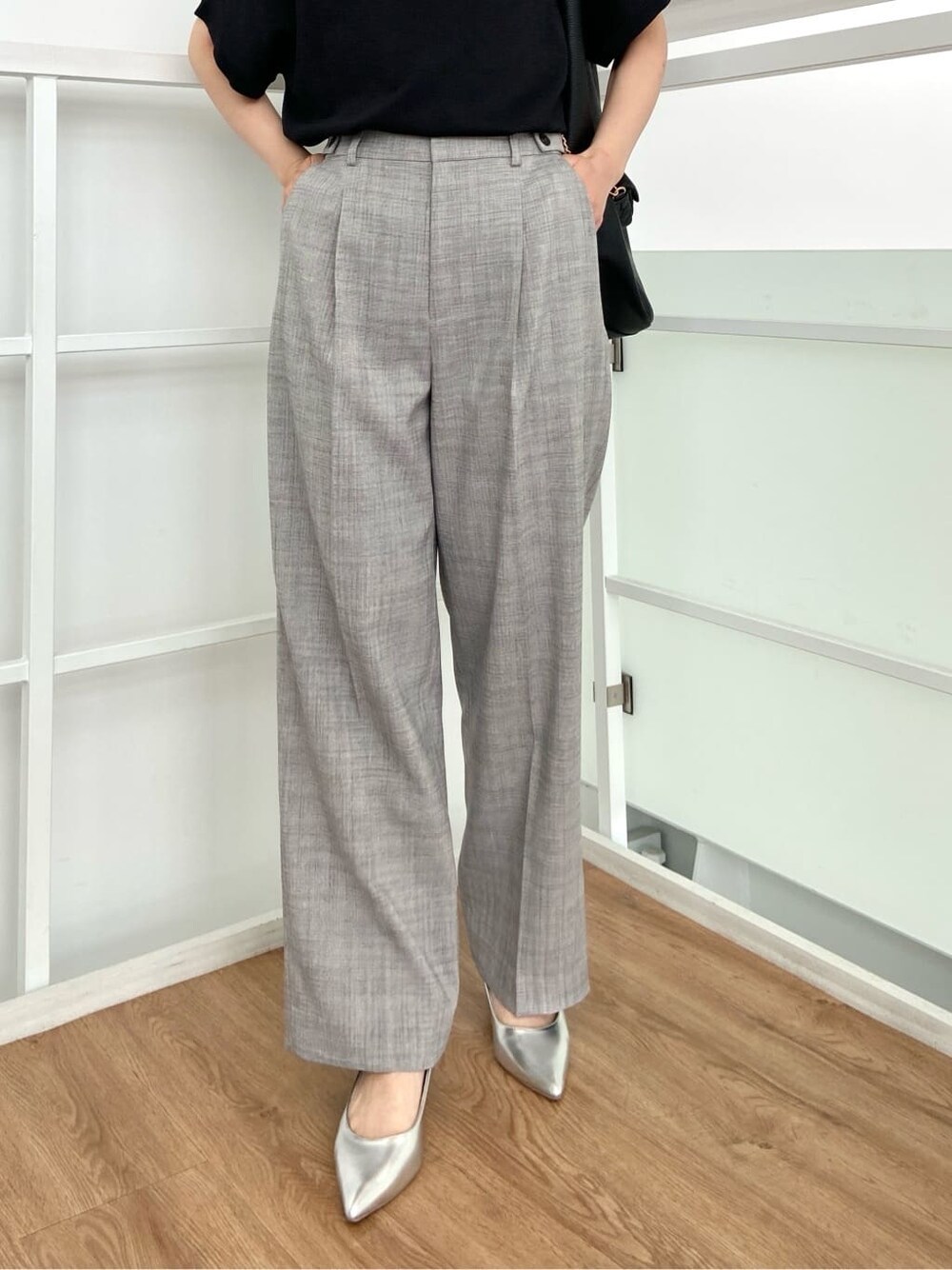 ブラック系のニット/セーター、グレー系のその他パンツ、ブラック系のトートバッグを着用したレディースの春コーディネートの7枚目の写真
