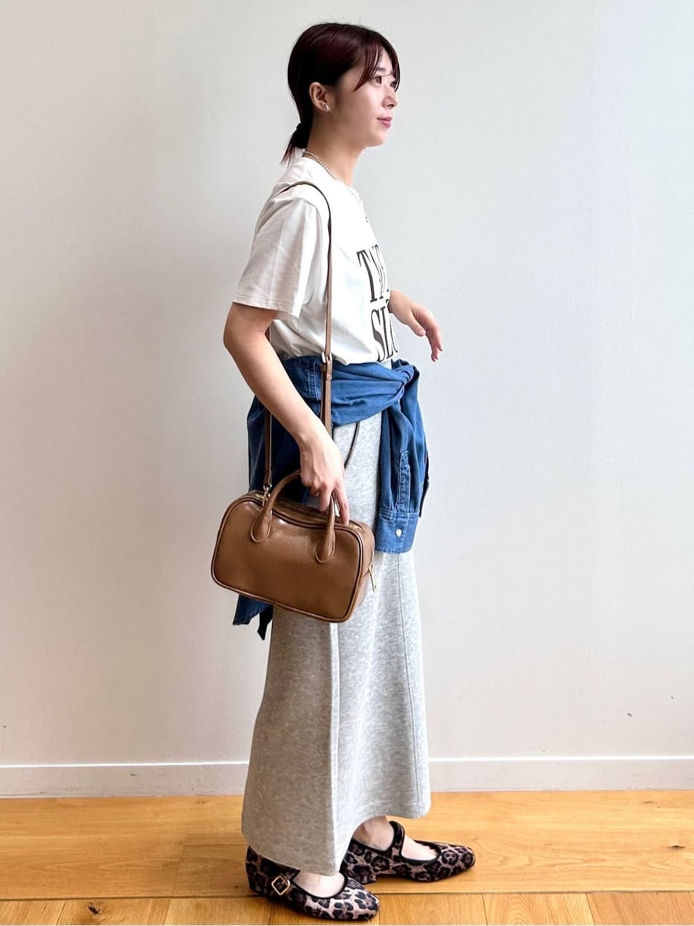 ホワイト系のTシャツ/カットソー、ブルー系のシャツ/ブラウス、グレー系のスカートを着用したレディースの秋コーディネートの3枚目の写真