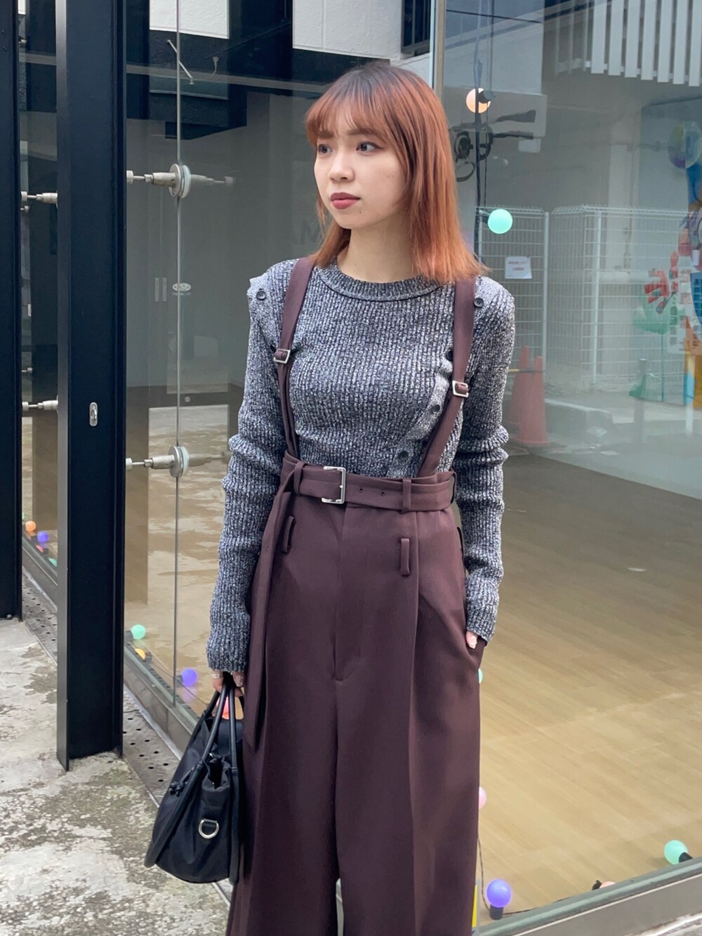 ブラック系のニット/セーター、ブラック系のショルダーバッグを着用したレディースの冬コーディネートの4枚目の写真