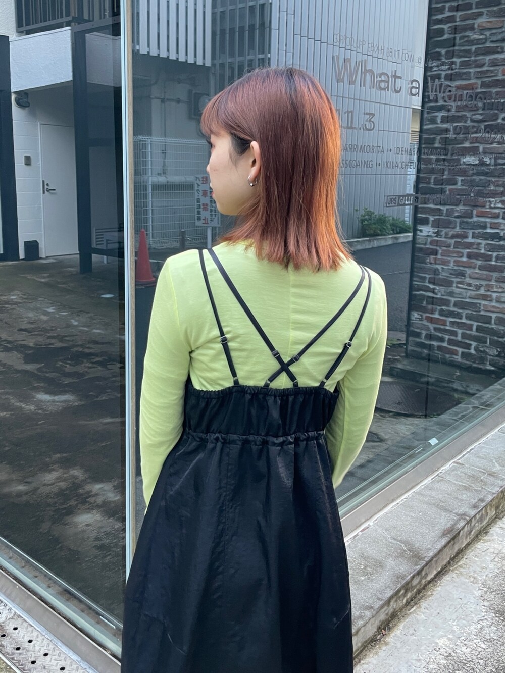 ブラック系のジャンパースカート、グリーン系のTシャツ/カットソーを着用したレディースの冬コーディネートの5枚目の写真