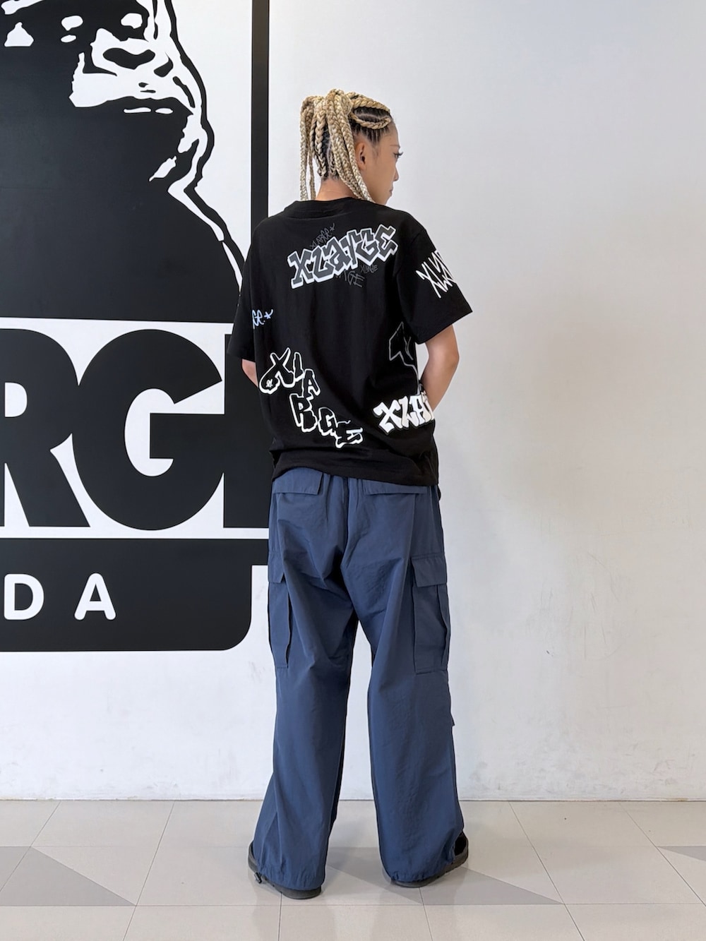 ブラック系のTシャツ/カットソー、ブルー系のカーゴパンツを着用したレディースの夏コーディネートの2枚目の写真