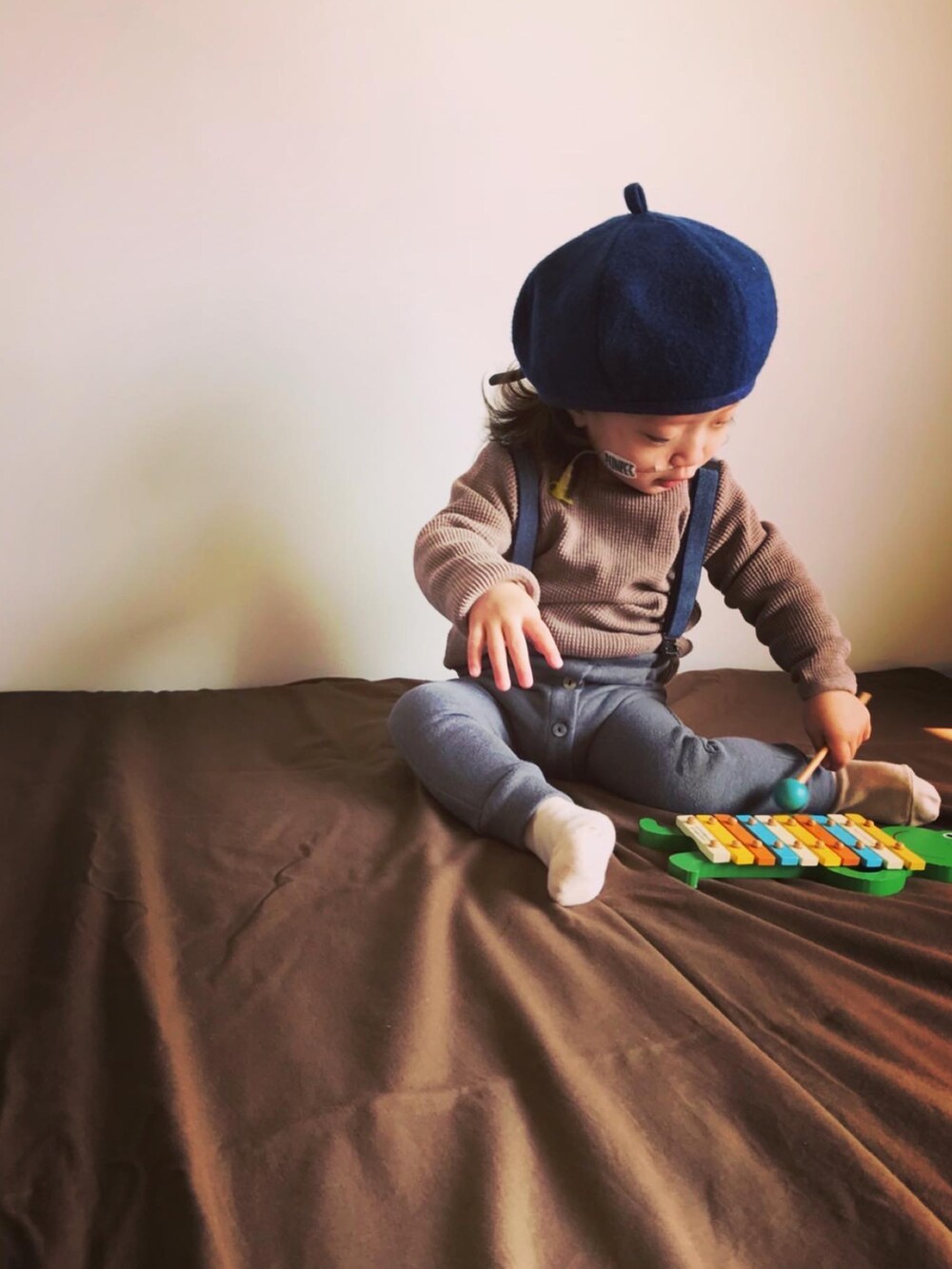 ブラウン系のトップス、グレー系のパンツを着用したキッズの秋コーディネートの2枚目の写真