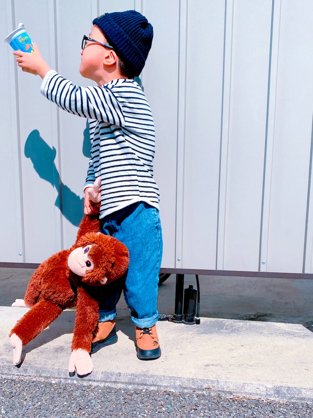 ホワイト系のトップス、ブラウン系のブーツ、ブルー系のニットキャップ/ビーニーを着用したキッズの秋コーディネートの2枚目の写真