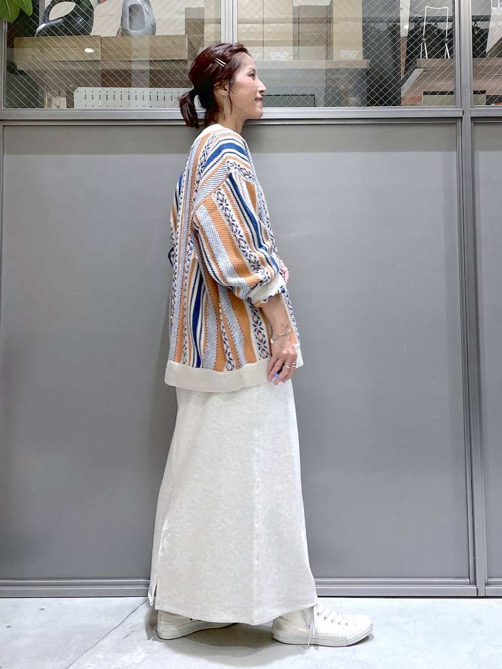 ホワイト系のTシャツ/カットソー、ベージュ系のワンピース、オレンジ系のカーディガン/ボレロを着用したレディースの夏コーディネートの3枚目の写真