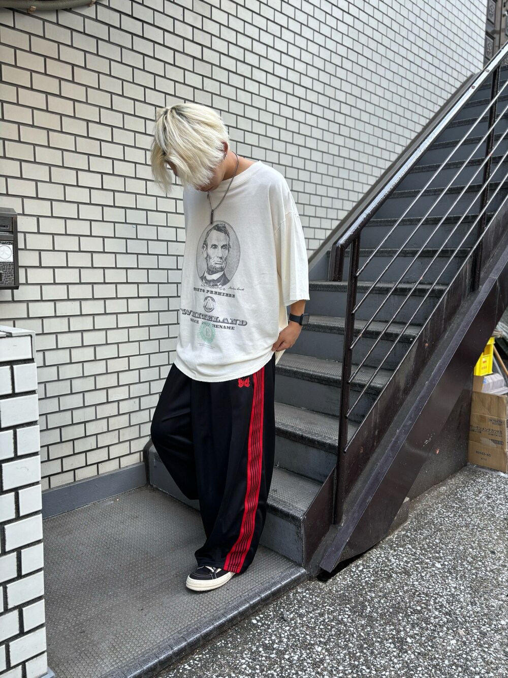 ホワイト系のTシャツ/カットソー、ブラック系のパンツを着用したメンズの夏コーディネートの2枚目の写真