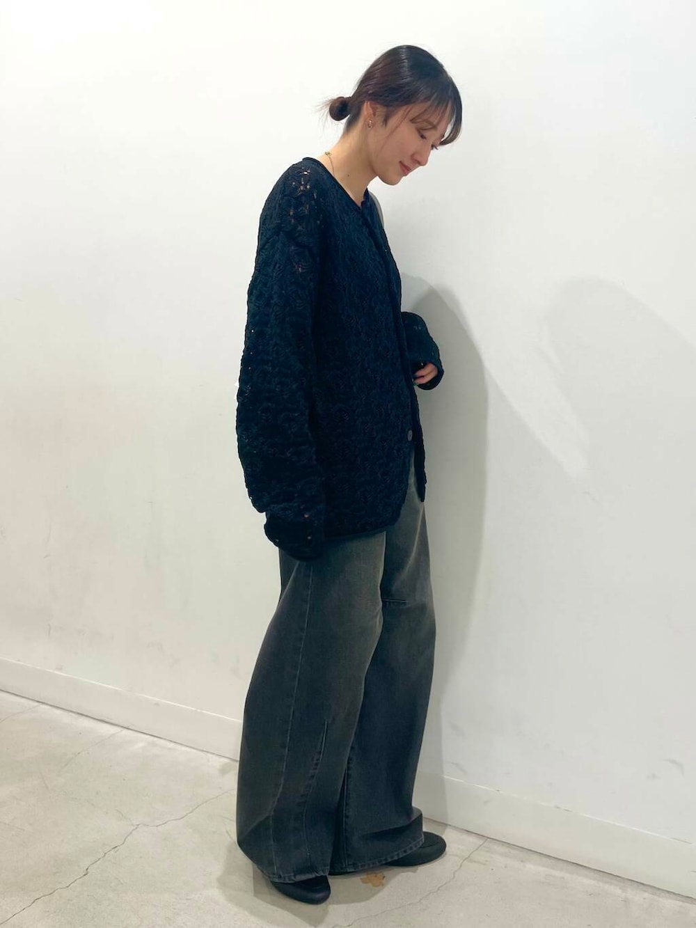 グレー系のショルダーバッグ、ブラック系のカーディガン/ボレロ、ブラック系のローファーを着用したレディースの春コーディネートの2枚目の写真