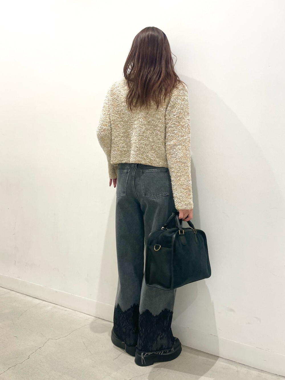 ブラック系のその他シューズ、グレー系のボストンバッグ、グレー系のデニムパンツを着用したレディースの冬コーディネートの3枚目の写真