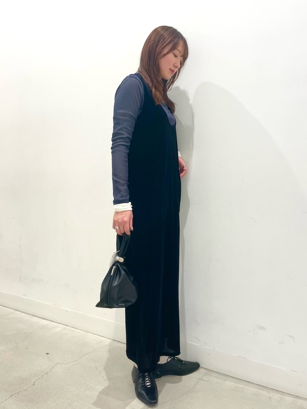 ブラック系のその他シューズ、ブラック系のワンピース、ブラック系のハンドバッグを着用したレディースの冬コーディネートの2枚目の写真