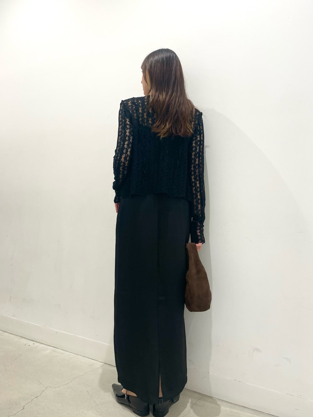 ブラック系のパンプス、ブラウン系のハンドバッグ、ブラック系のワンピースを着用したレディースの秋コーディネートの3枚目の写真