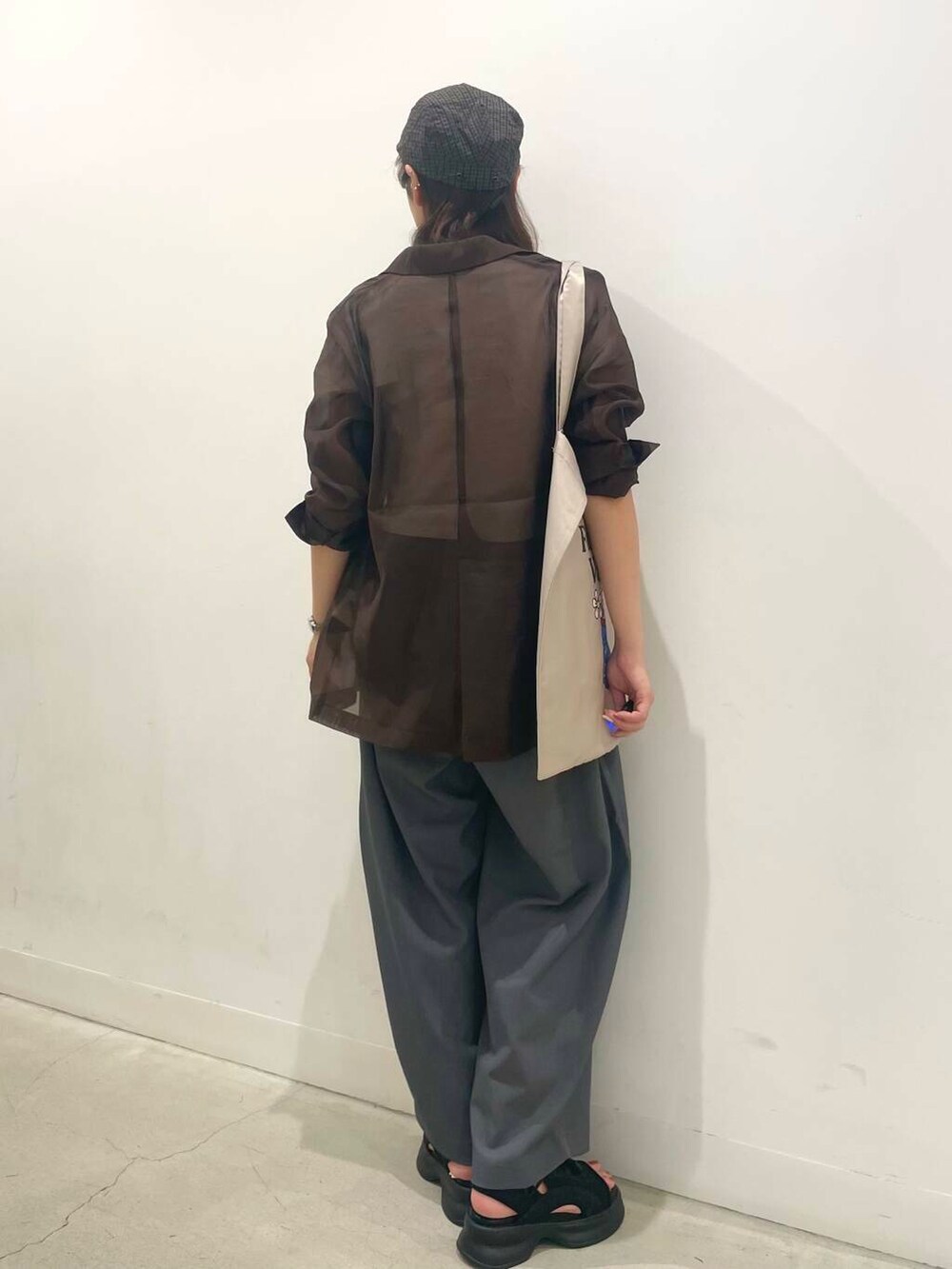 ブラック系のサンダル、その他のTシャツ/カットソー、グレー系のトートバッグを着用したレディースの夏コーディネートの3枚目の写真