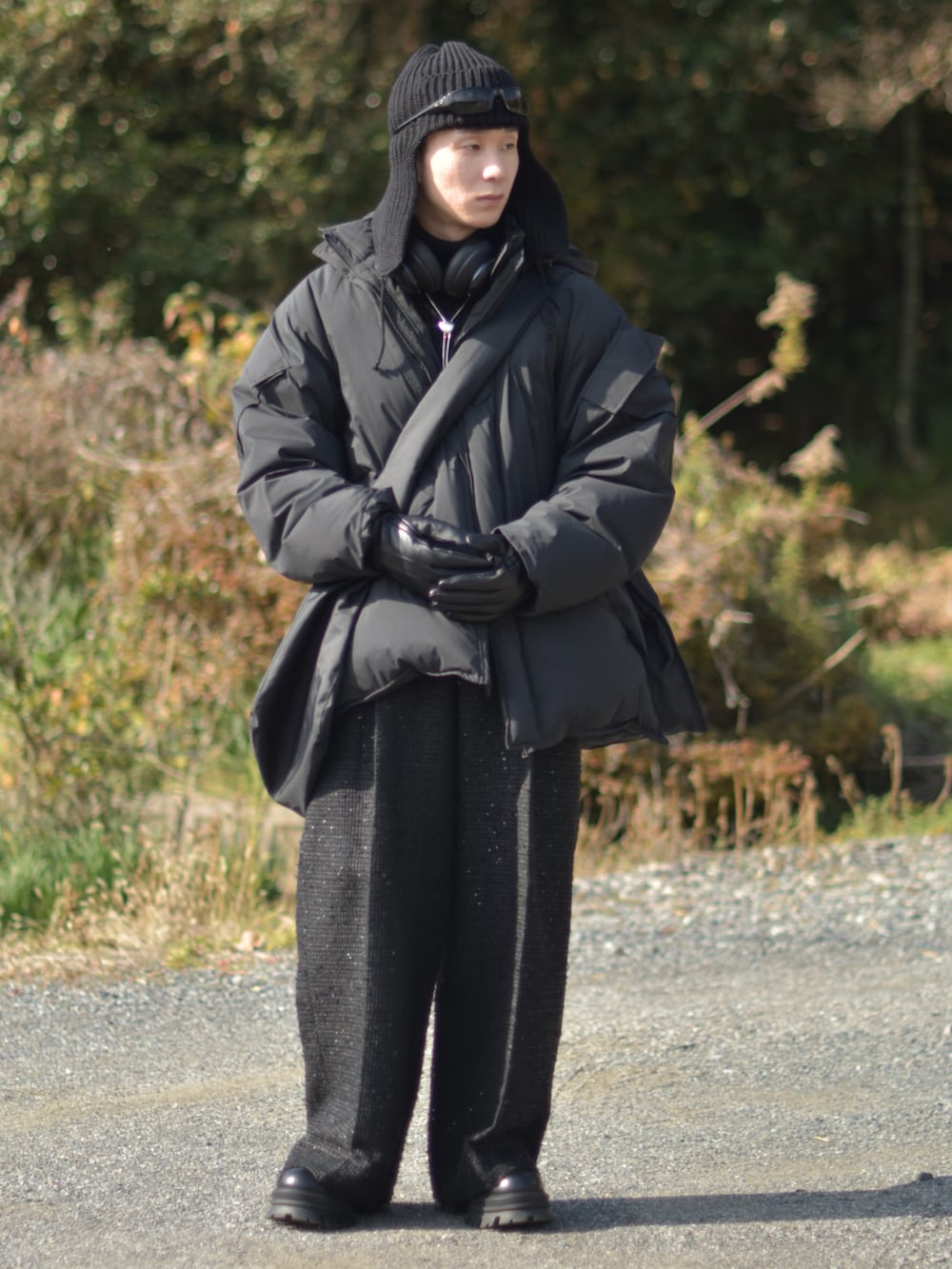 ブラック系のダウンジャケット/コート、ブラック系のスラックス、ブラック系のブーツを着用したメンズの冬コーディネートの3枚目の写真