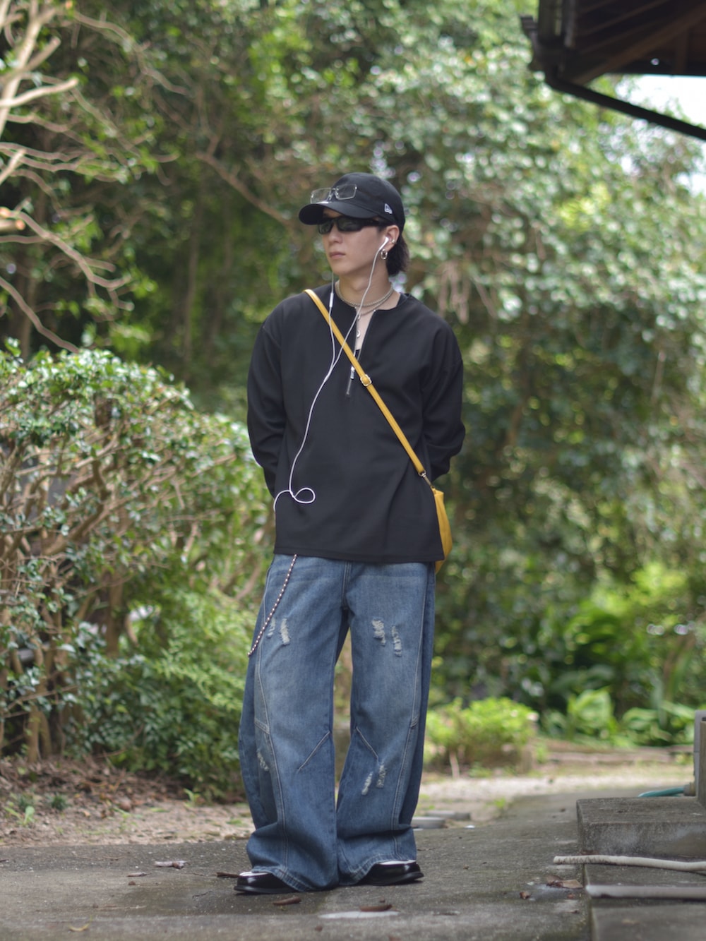 ブラック系のローファー、ブラック系のTシャツ/カットソー、ブルー系のデニムパンツを着用したメンズの秋コーディネートの2枚目の写真