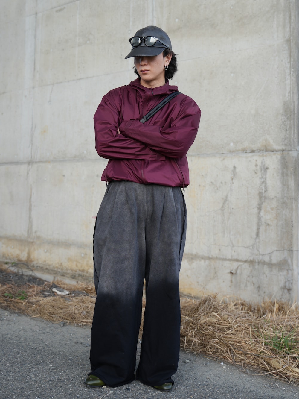 ブラック系のスウェットパンツ、ブラック系のショルダーバッグ、グリーン系のローファーを着用したメンズの春コーディネートの3枚目の写真