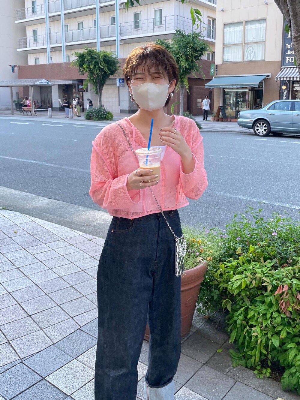 ピンク系のカーディガン/ボレロ、ブルー系のデニムパンツを着用したレディースの春コーディネートの4枚目の写真