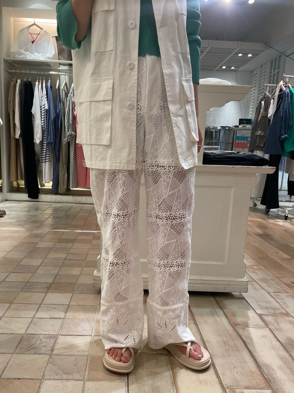 ホワイト系のベスト、グリーン系のカーディガン/ボレロ、ホワイト系のその他パンツを着用したレディースの春コーディネートの4枚目の写真