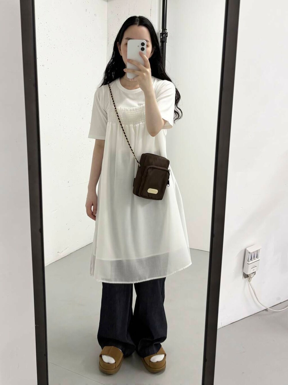ブラウン系のショルダーバッグ、ホワイト系のTシャツ/カットソーを着用したレディースの夏コーディネートの2枚目の写真